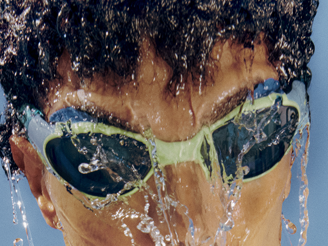 Shop Biofuse goggles – man wearing blue and white swim goggles.
